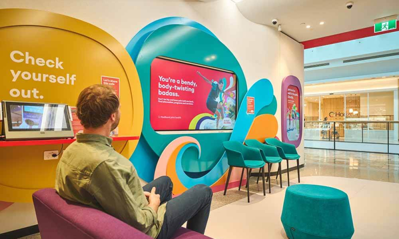 Medibank the Glen interior with a man looking at the digital screens