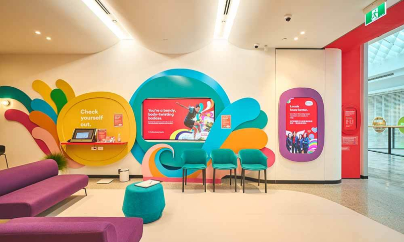 Interior shot of the Medibank the Glen with colourful store design and digital screens