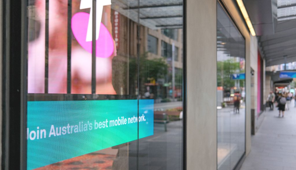 Telstra shopfront with an LED screen in the window facing a busy city street