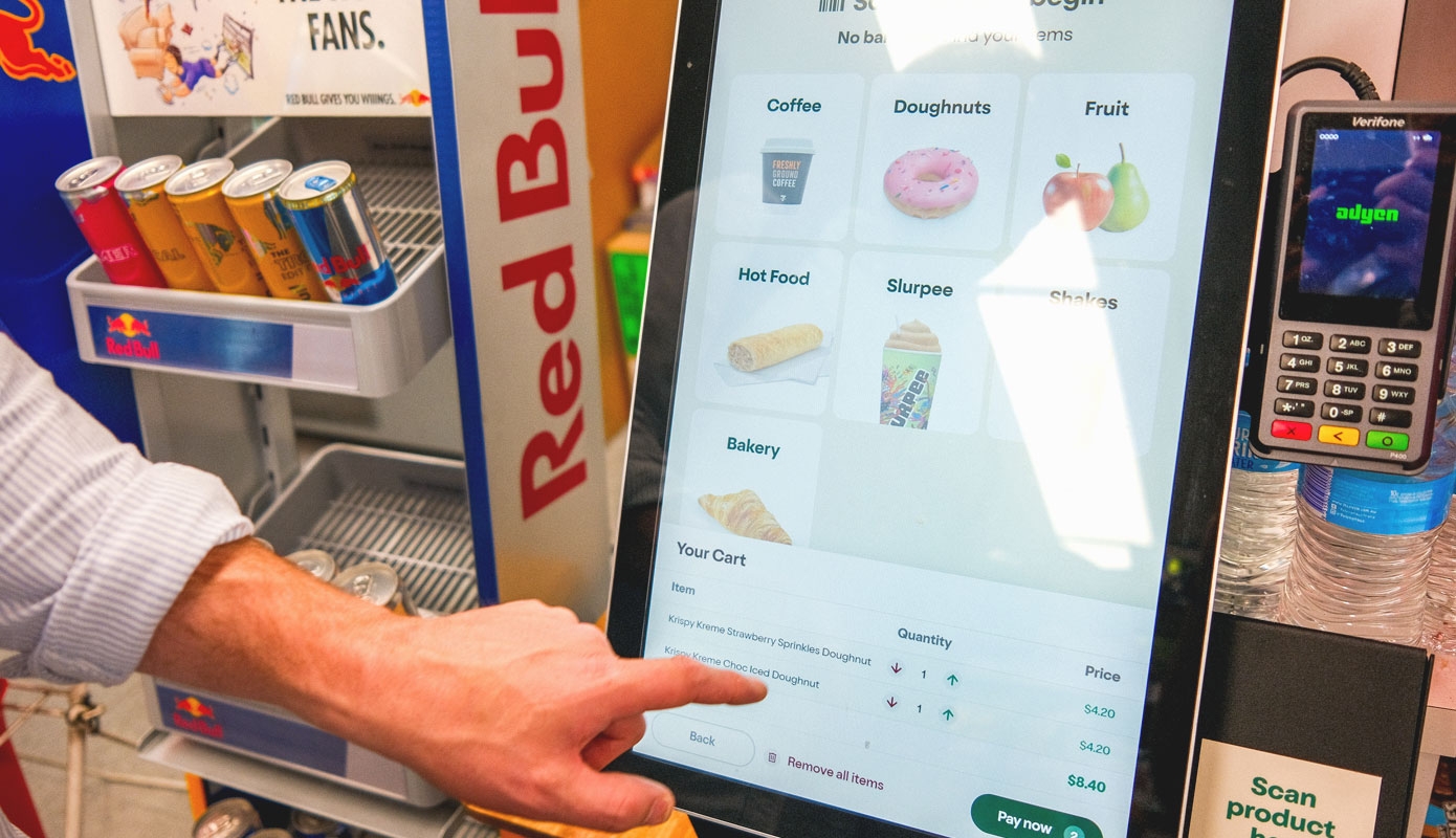 7-Eleven-kiosk-hero-image A touchscreen kiosk inside a 7-eleven convenience store