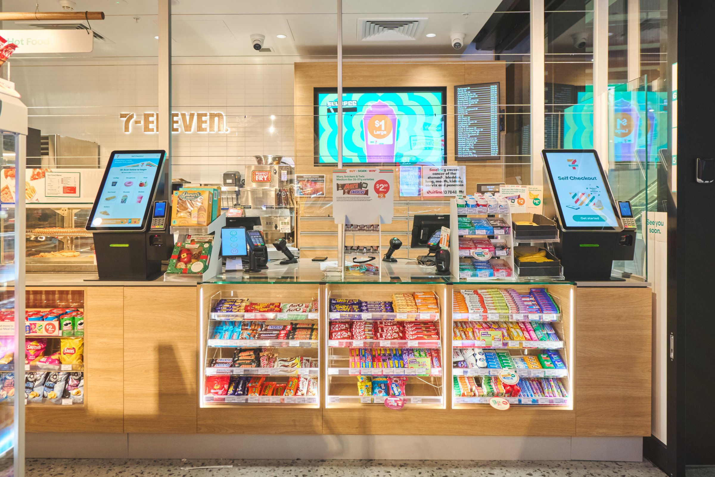 7-Eleven countertop self-checkout kiosks at the service counter